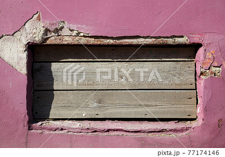 Picture of cracked wall with peeling pink paint Picture of cracked wall with peeling pink paint 77174146