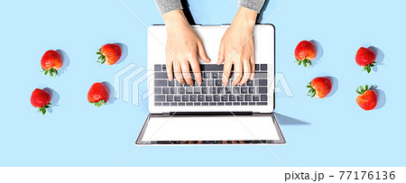 Woman using a laptop computer with fresh...の写真素材 [77176136] - PIXTA