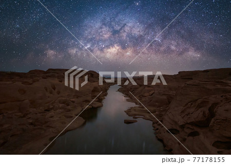 Sam Phan Bok with milky way and stars at night, Ubon Ratchathani, Thailand. Dry rock reef in the Mekong River with mountain hills. Nature landscape background. Grand Canyon of Thailand. Sam Phan Bok with milky way and stars at night, Ubon Ratchathani, Thailand. Dry rock reef in the Mekong River with mountain hills. Nature landscape background. Grand Canyon of Thailand. 77178155