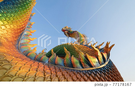 Serpent statue sculpture of chedi stupa pagoda Buddhism in Wat Phra That Nong Bua Dhammyuttika temple, Ubon Ratchathani district, Thailand. 77178167