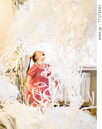 Happy kid on party, little girl having fun with confetti Happy kid on party, little girl having fun with confetti 77178367