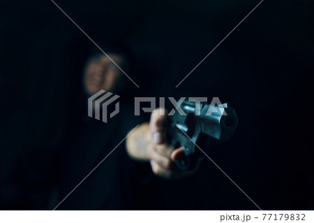 Firearm in man's hand. Firearm in man's hand. 77179832