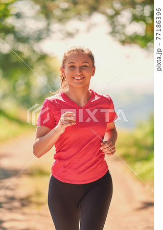 woman enjoying in a healthy lifestyle while jogging 77186396