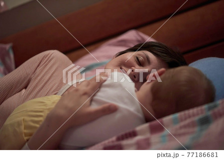mother is playing with baby at home 77186681