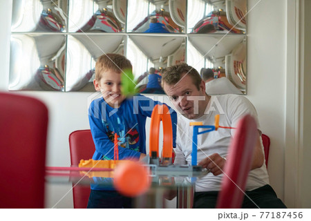 Father and children playing car toy game Father and children playing car toy game 77187456