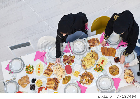 Top view of young muslim women preparing food for iftar during Ramadan Top view of young muslim women preparing food for iftar during Ramadan 77187494