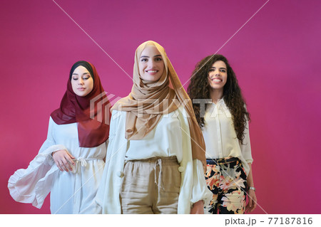 Young muslim women posing on pink background 77187816