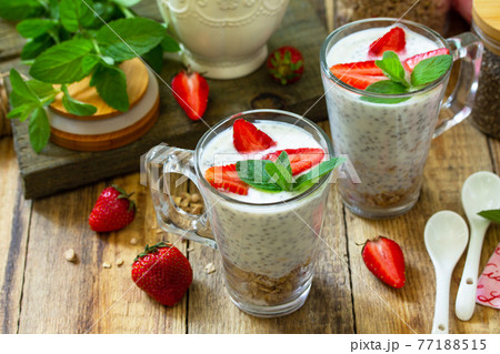 Healthy eating. Breakfast concept. Homemade granola with strawberry, yogurt, chia seeds and fresh berries on a rustic table. 77188515