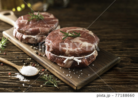 Fresh raw pieces of beef meat on a cutting board 77188660