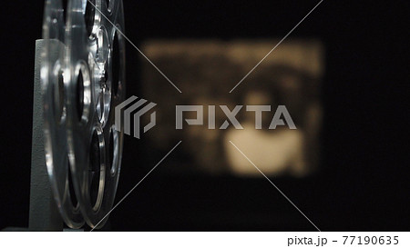 Photo of old film projector filming on black 77190635