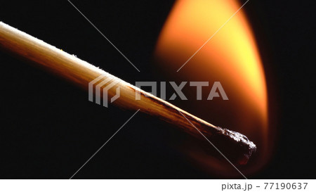 Photo of burning wooden matchstick on black 77190637
