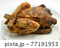 A genuine roast chicken on a white plate. Perfect shot for healthy diets, cooking and breeding. 77191953