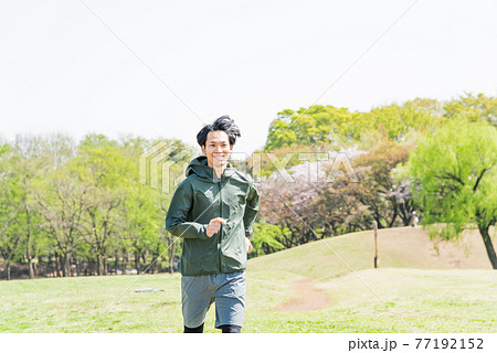 公園でランニングをする若い男性 公園でランニングをする若い男性 77192152