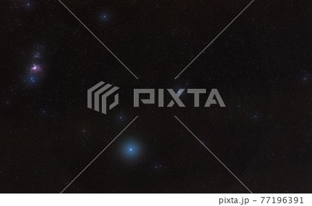 Winter night sky with purple Orion nebula, bright blue Rigel star - diffused through some clouds - in bottom lower part, long exposure photo Winter night sky with purple Orion nebula, bright blue Rigel star - diffused through some clouds - in bottom lower part, long exposure photo 77196391