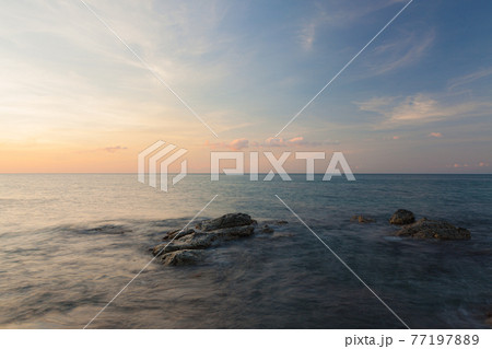 Waves and rocks shore long exposure Waves and rocks shore long exposure 77197889