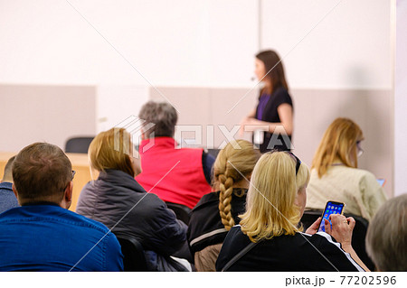 Business speaker doing presentation to audience Business speaker doing presentation to audience 77202596