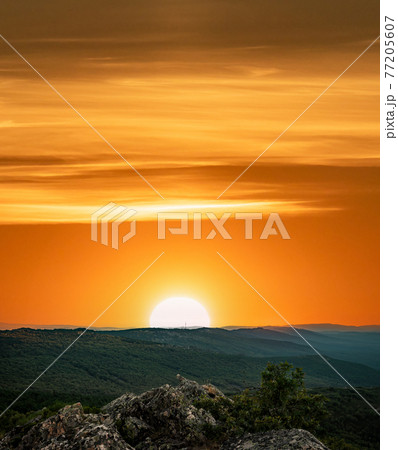 Orange sunset with text space over the mountain range 77205607