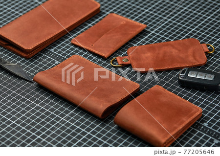 Set of handmade leather goods, key holder rings, wallet, purse, notepad, handbook. Handcrafted leather goods, close-up 77205646