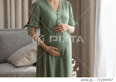 Close up of pregnant woman touch caress baby bump Close up of pregnant woman touch caress baby bump 77206407