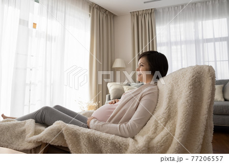 Happy young pregnant woman relax at home 77206557