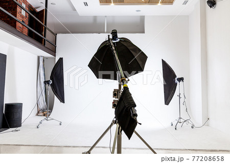 Empty photo studio with lighting equipment. Photographer workplace interior with professional tool set gear. Flash light white background scenes ready for studio shooting. Modern photographer studio Empty photo studio with lighting equipment. Photographer workplace interior with professional tool set gear. Flash light white background scenes ready for studio shooting. Modern photographer studio 77208658