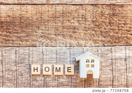 Miniature toy house with inscription HOME letters word on wooden background. Mortgage property insurance dream home concept. Flat lay top view, copy space Miniature toy house with inscription HOME letters word on wooden background. Mortgage property insurance dream home concept. Flat lay top view, copy space 77208708