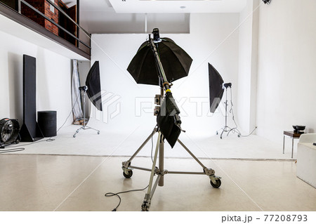 Empty photo studio with lighting equipment. Photographer workplace interior with professional tool set gear. Flash light white background scenes ready for studio shooting. Modern photographer studio Empty photo studio with lighting equipment. Photographer workplace interior with professional tool set gear. Flash light white background scenes ready for studio shooting. Modern photographer studio 77208793
