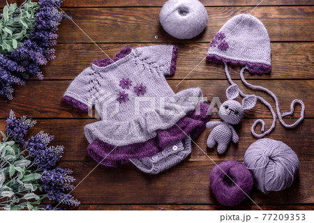 Toy hare tied from woolen threads on a dark background Toy hare tied from woolen threads on a dark background 77209353