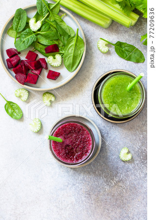 Vegan diet and nutrition, healthy detox, vegetarian concepts drinks. Beet smoothie and Green smoothie celery and spinach on a gray stone countertop. Top view flat lay. Copy space. 77209636