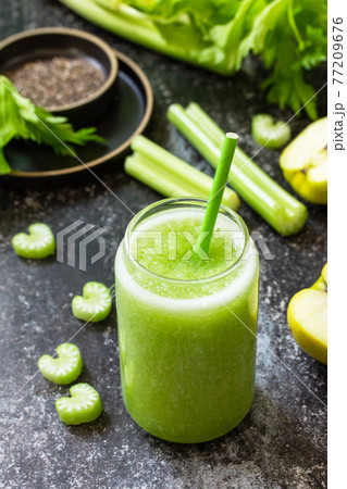 Healthy diet and nutrition, vegan, alkaline, vegetarian concept. Green smoothie with celery and apple on a dark stone countertop. 77209676