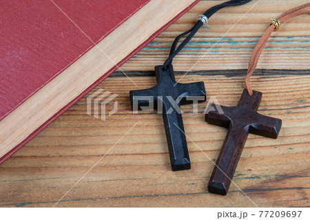 Book and two wooden crosses on a wooden table. Faith, belief and mental health concept Book and two wooden crosses on a wooden table. Faith, belief and mental health concept 77209697