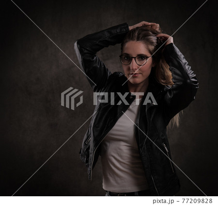 Attractive young woman poses for the camera Attractive young woman poses for the camera 77209828