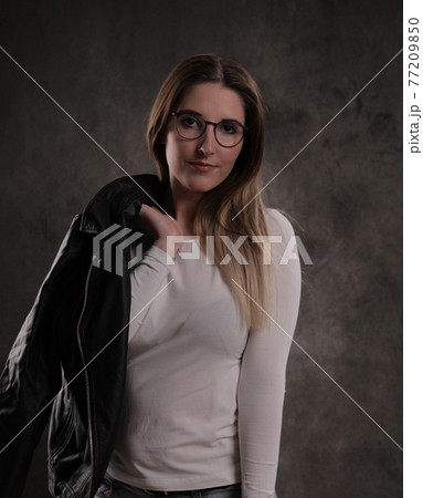 Photo shooting with a young attractive woman in a studio Photo shooting with a young attractive woman in a studio 77209850