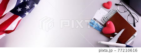 Domestic tourism banner concept with airplane model, boarding pass documents, smartphone and American flag. 77210616