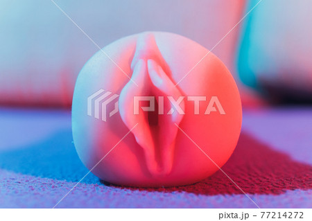 Close-up of male sex toy, realistic vagina masturbator. Close-up of male sex toy, realistic vagina masturbator. 77214272