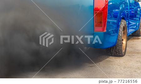 air pollution crisis in city from diesel vehicle exhaust pipe on road 77216556