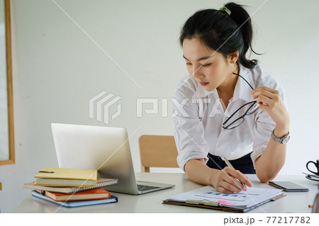Business woman hand holding pen and paperwork, account or saving money or insurance concept. Business woman hand holding pen and paperwork, account or saving money or insurance concept. 77217782