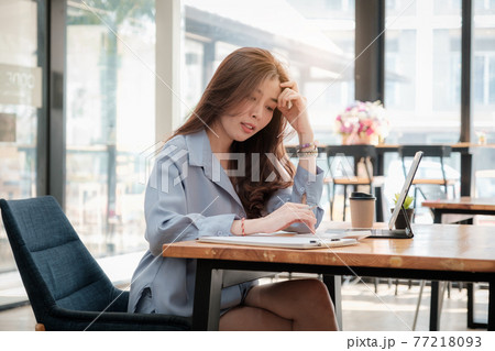 Young asian accountant using calculations. Savings, finances, tax and economy concept. 77218093