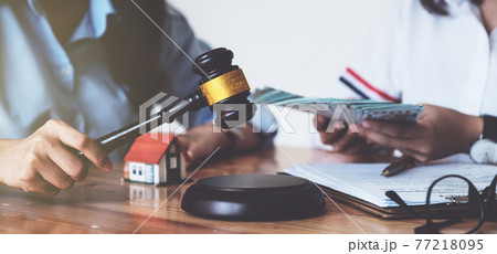 Business woman and lawyers discussing contract papers on wooden desk in office. Law, legal services, advice, Justice concept. Business woman and lawyers discussing contract papers on wooden desk in office. Law, legal services, advice, Justice concept. 77218095
