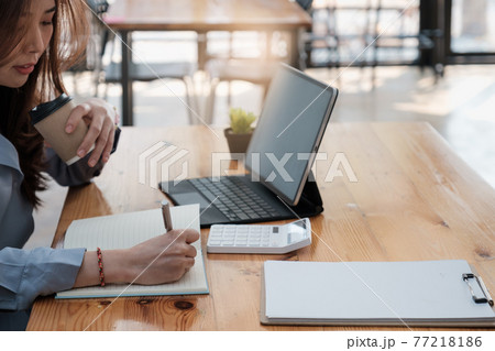Business Accountant In office doing Accounting Work with coffee in the morning. Business Accountant In office doing Accounting Work with coffee in the morning. 77218186