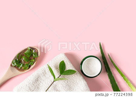 Top view with aloe vera juice, organic cream, gel, towel and green leaves. Top view with aloe vera juice, organic cream, gel, towel and green leaves. 77224398
