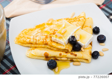 Crepes with brie and honey Crepes with brie and honey 77226007