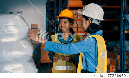 Female warehouse worker working at the storehouse Female warehouse worker working at the storehouse 77226089