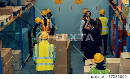 Many people , workers and manger work in warehouse or storehouse Many people , workers and manger work in warehouse or storehouse 77226096