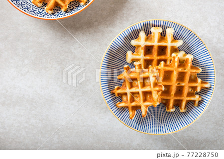 Traditional homemade belgian waffles on light background 77228750
