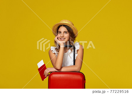 teenager girl with red suitcase, passport with ticket 77229516