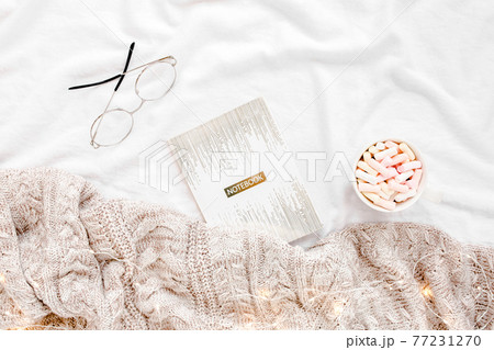 Home office on bed with warm plaid. Mockup card. Flat lay, top view Home office on bed with warm plaid. Mockup card. Flat lay, top view 77231270