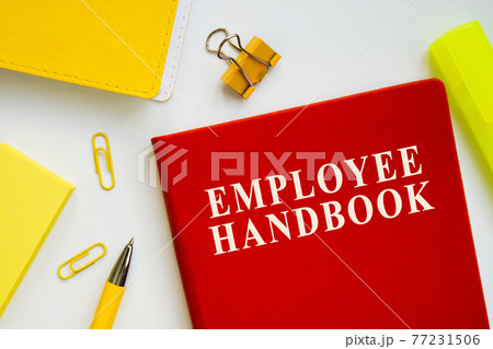 Employee handbook guide on the office desk. 77231506