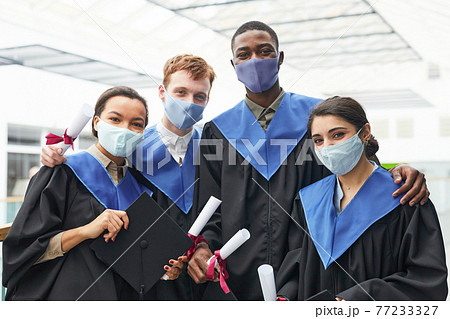 Portrait of diverse college graduates wearing masks Portrait of diverse college graduates wearing masks 77233327