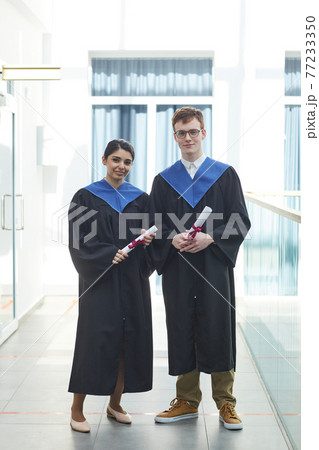 Two young college graduates Two young college graduates 77233350